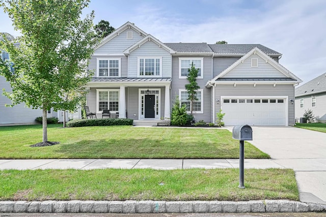 craftsman inspired home featuring a front lawn and a garage