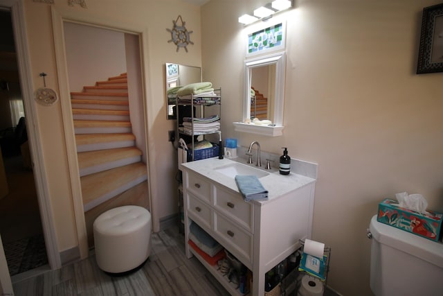 bathroom featuring vanity and toilet