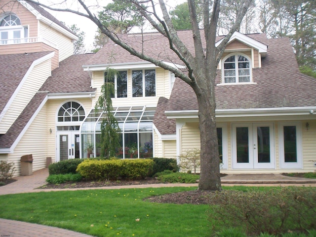 view of front of property featuring french doors and a front lawn