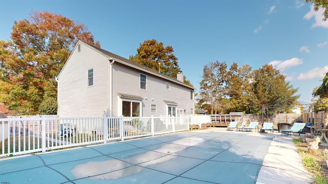 view of swimming pool with a wooden deck and a patio area