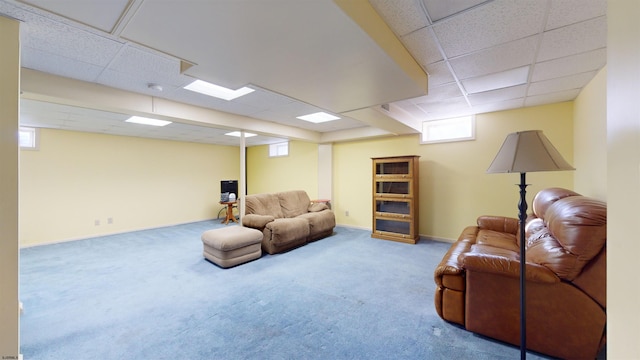 living room featuring a paneled ceiling and carpet floors