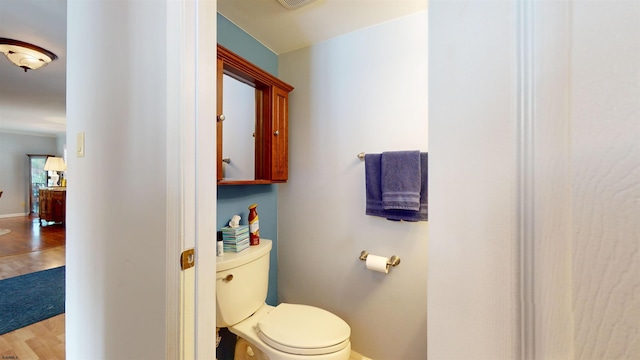 bathroom with toilet and hardwood / wood-style flooring