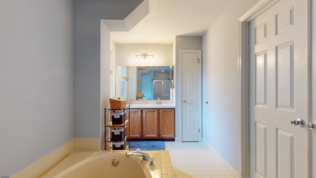 bathroom with vanity, tile patterned floors, and a bathing tub