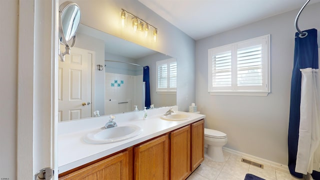 bathroom featuring vanity, tile patterned flooring, toilet, and walk in shower