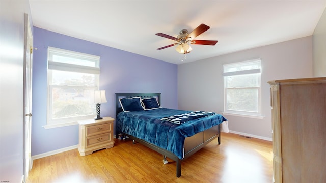 bedroom with light hardwood / wood-style flooring and ceiling fan