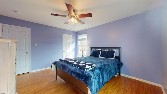 bedroom with light hardwood / wood-style flooring and ceiling fan