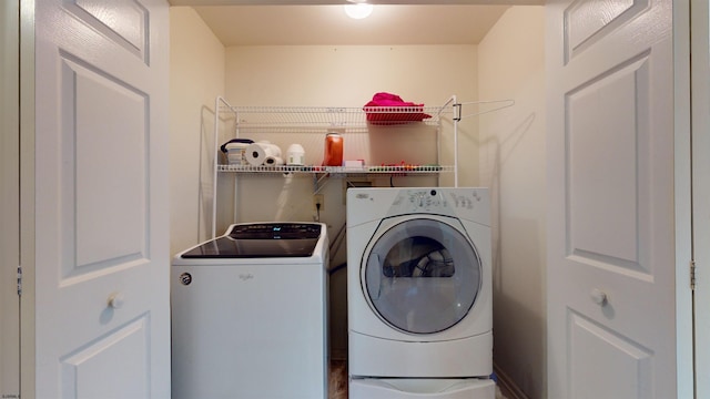 clothes washing area with washing machine and dryer