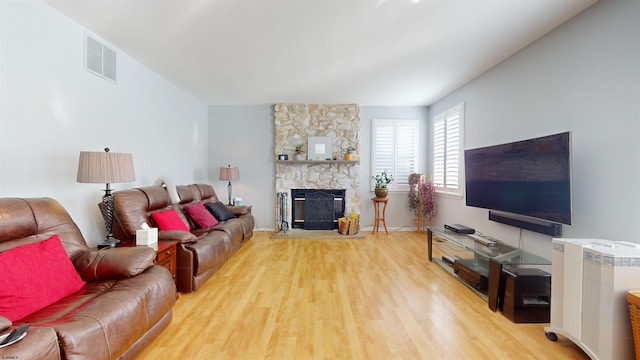 living room with hardwood / wood-style floors and a fireplace