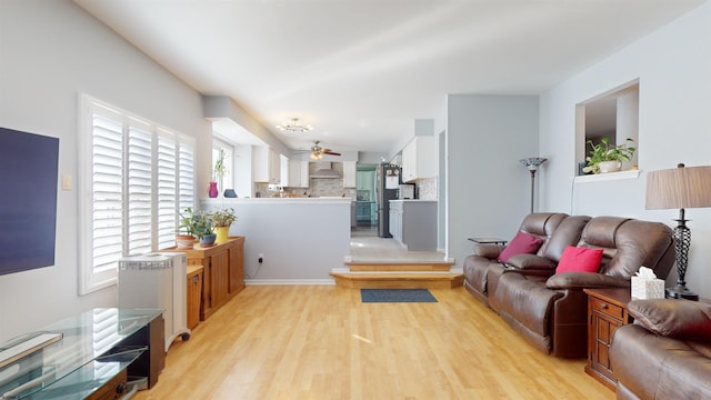 living room featuring light hardwood / wood-style flooring and ceiling fan