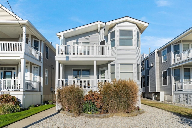 view of front of home with covered porch and a balcony