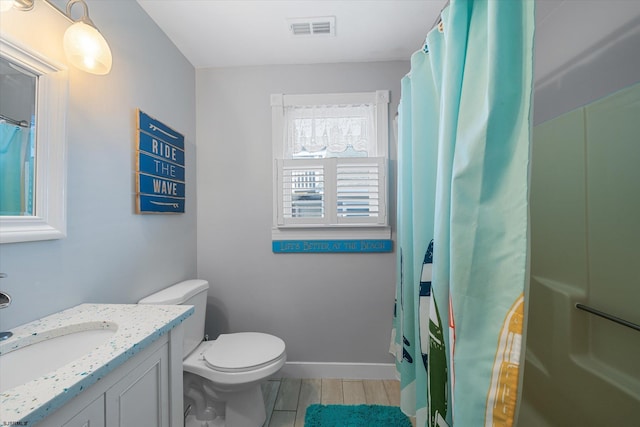 bathroom with toilet, curtained shower, vanity, and hardwood / wood-style flooring