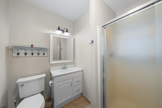 bathroom featuring vanity, toilet, a shower with shower door, and tile patterned flooring