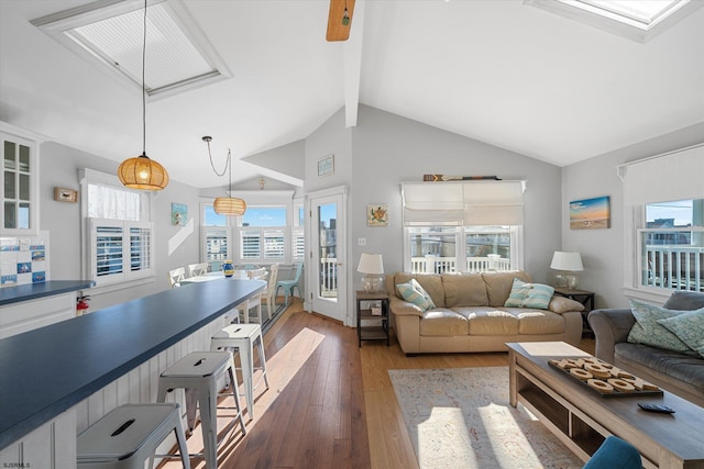 living room featuring lofted ceiling with beams and dark wood-type flooring