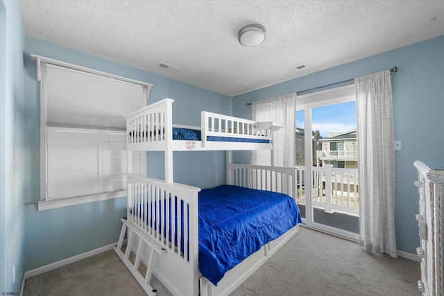 carpeted bedroom featuring a textured ceiling