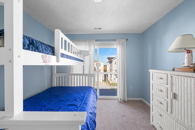 carpeted bedroom featuring a textured ceiling