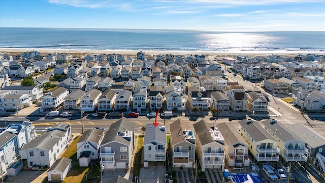 drone / aerial view featuring a water view and a beach view