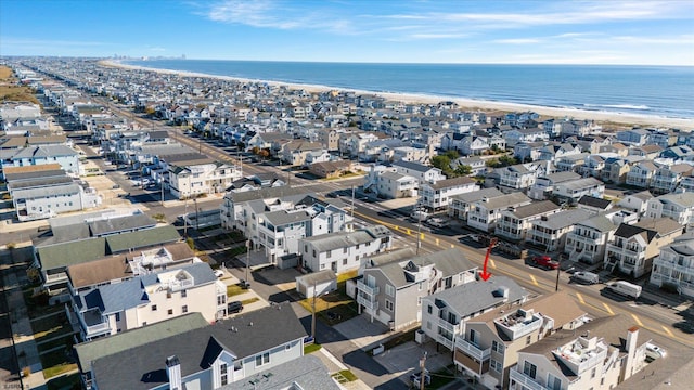 bird's eye view featuring a water view and a beach view