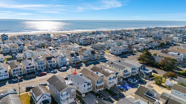 drone / aerial view with a water view and a view of the beach