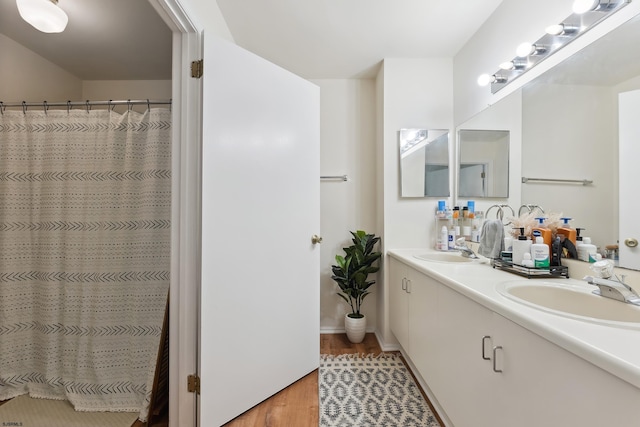 bathroom with vanity, hardwood / wood-style floors, and walk in shower