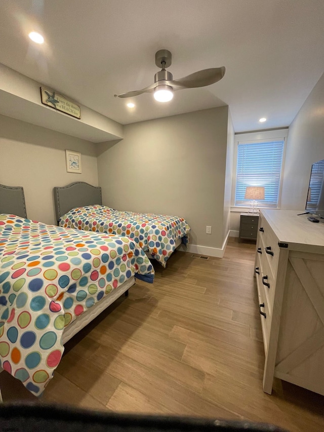 bedroom featuring light hardwood / wood-style flooring and ceiling fan