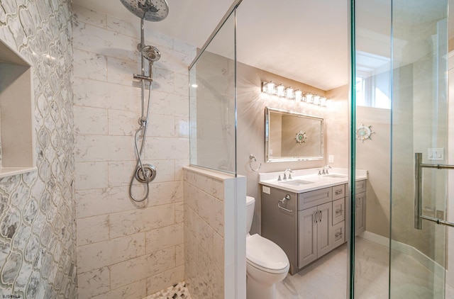 bathroom with toilet, an enclosed shower, and vanity