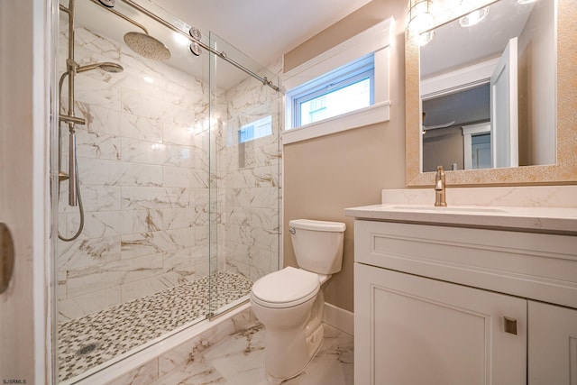 bathroom with toilet, vanity, and a shower with door