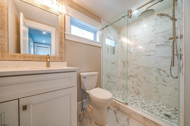 bathroom featuring toilet, a shower with shower door, and vanity