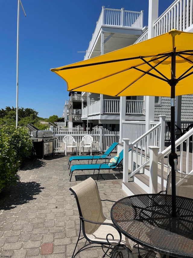 view of patio / terrace featuring a balcony and a grill