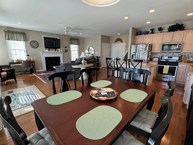 dining area featuring ceiling fan and hardwood / wood-style floors