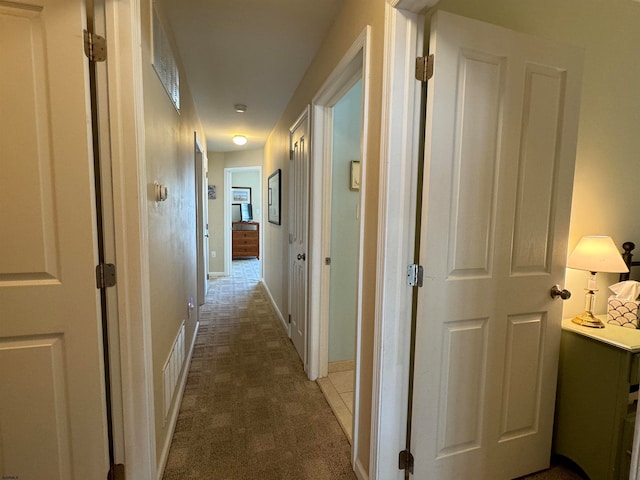 hallway with carpet floors