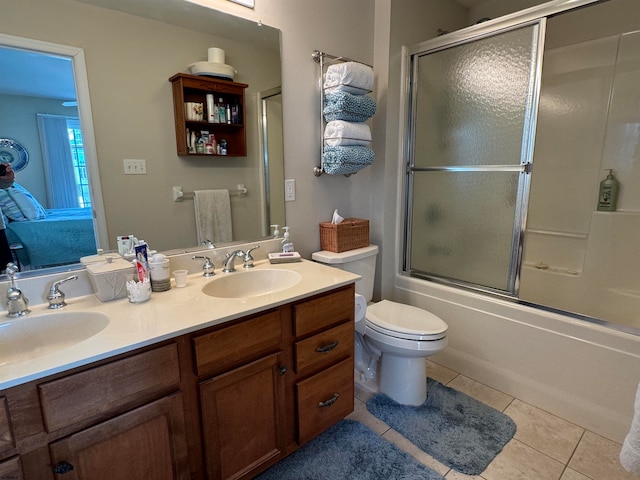 full bathroom with vanity, toilet, tile patterned floors, and combined bath / shower with glass door