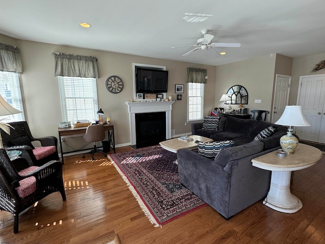 living room featuring a wealth of natural light, hardwood / wood-style flooring, and ceiling fan