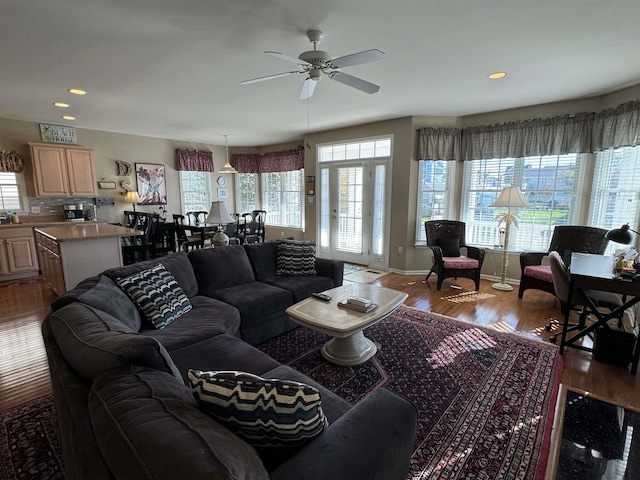 living room with light hardwood / wood-style flooring and ceiling fan