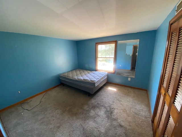 unfurnished bedroom featuring a closet and carpet floors