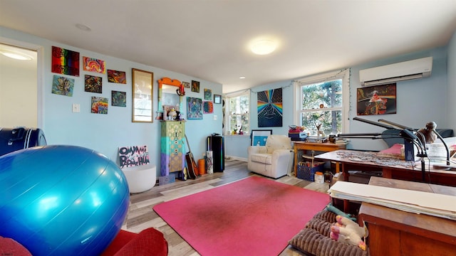 interior space featuring light hardwood / wood-style flooring and an AC wall unit