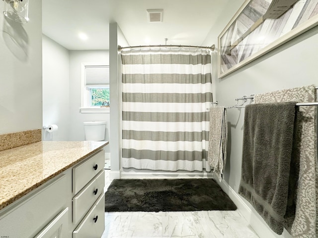 bathroom featuring vanity, a shower with curtain, and toilet