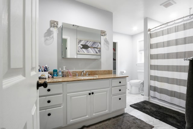 bathroom with vanity, curtained shower, and toilet