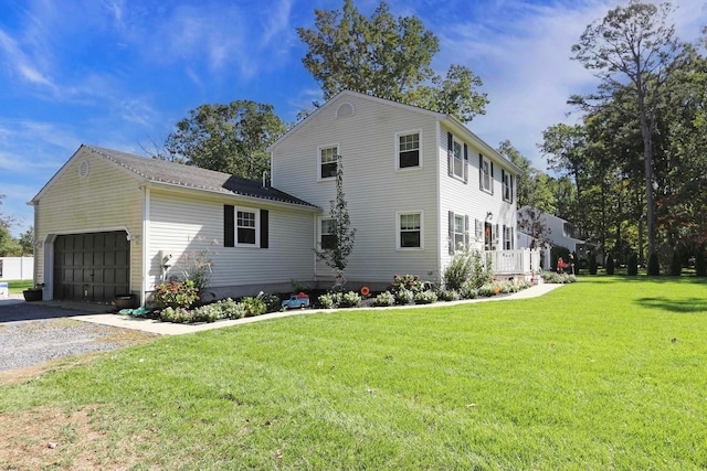 view of side of home featuring a garage and a lawn