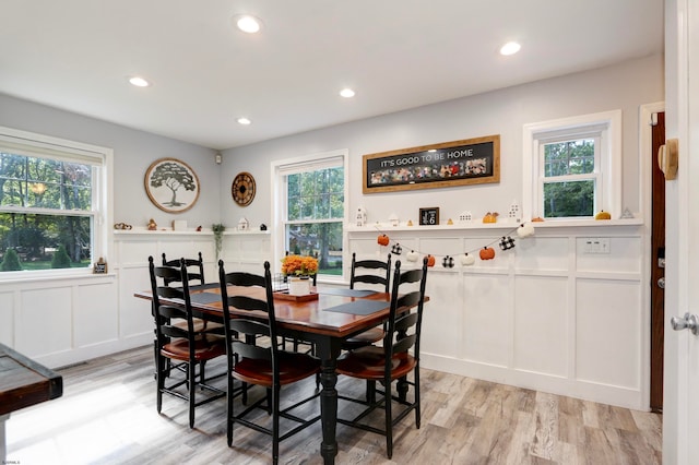 dining space with a wealth of natural light and light hardwood / wood-style flooring