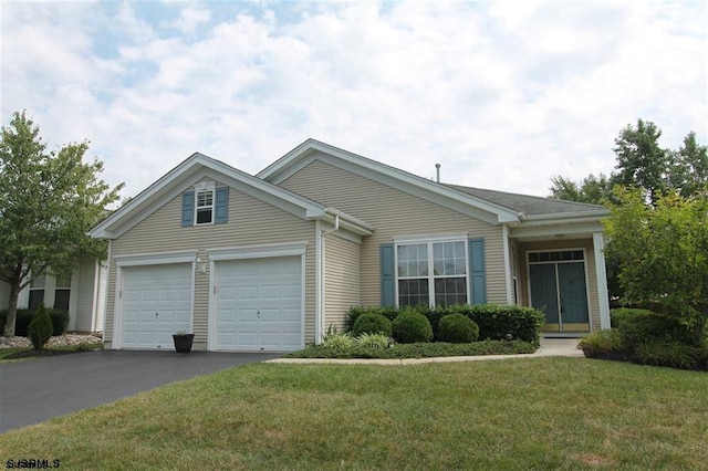 ranch-style house featuring a garage and a front lawn