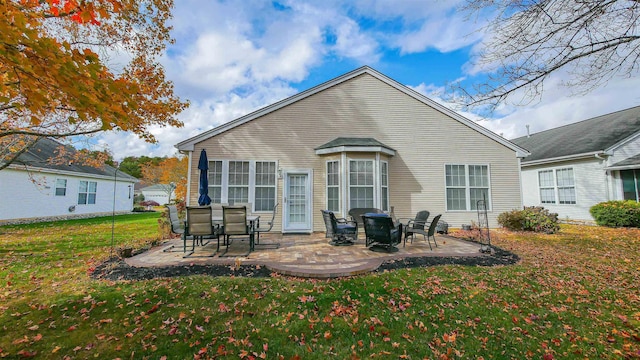 back of property featuring a patio area and a yard