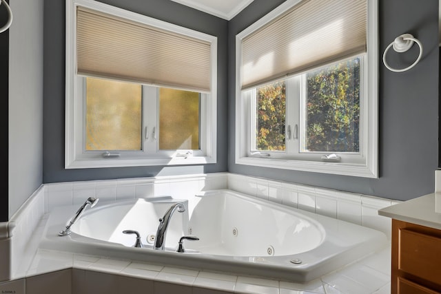 bathroom featuring vanity and tiled tub