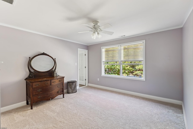 carpeted bedroom with crown molding and ceiling fan