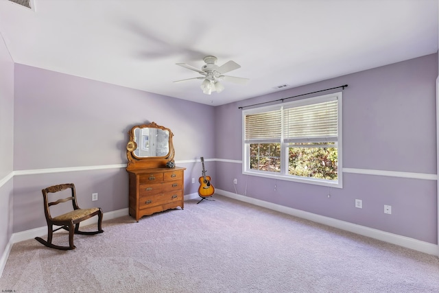 living area featuring ceiling fan and light colored carpet