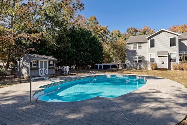 view of pool featuring a shed and a patio