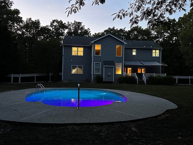 pool at dusk with a yard