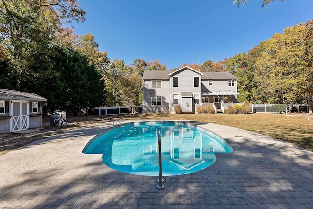 view of swimming pool with a patio area and a lawn