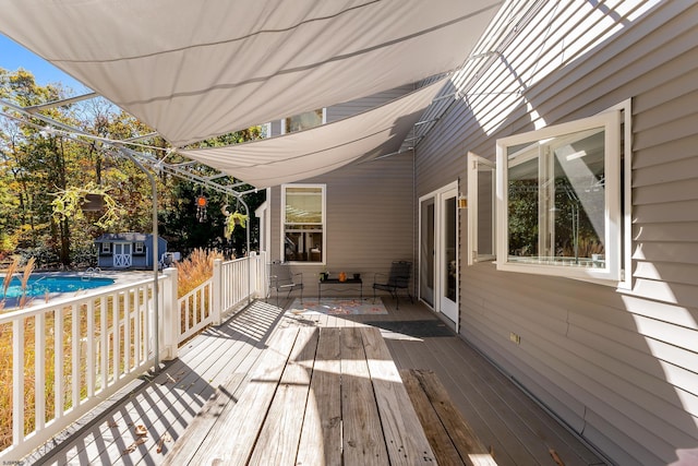 wooden deck with a storage shed