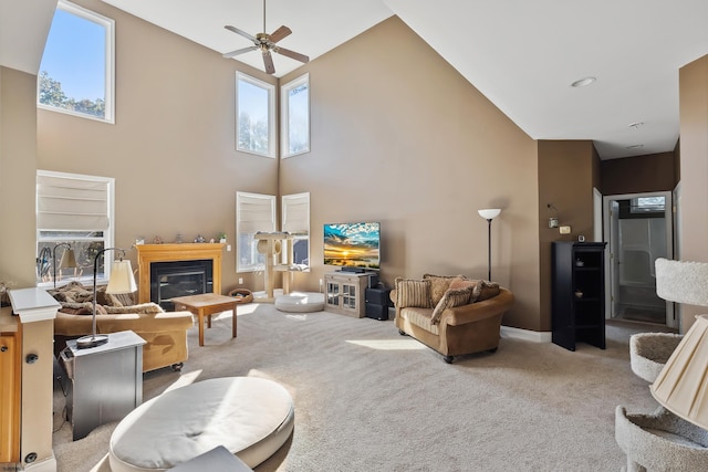 living room featuring light carpet, a healthy amount of sunlight, high vaulted ceiling, and ceiling fan