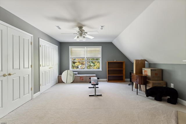 interior space with light carpet, lofted ceiling, and ceiling fan